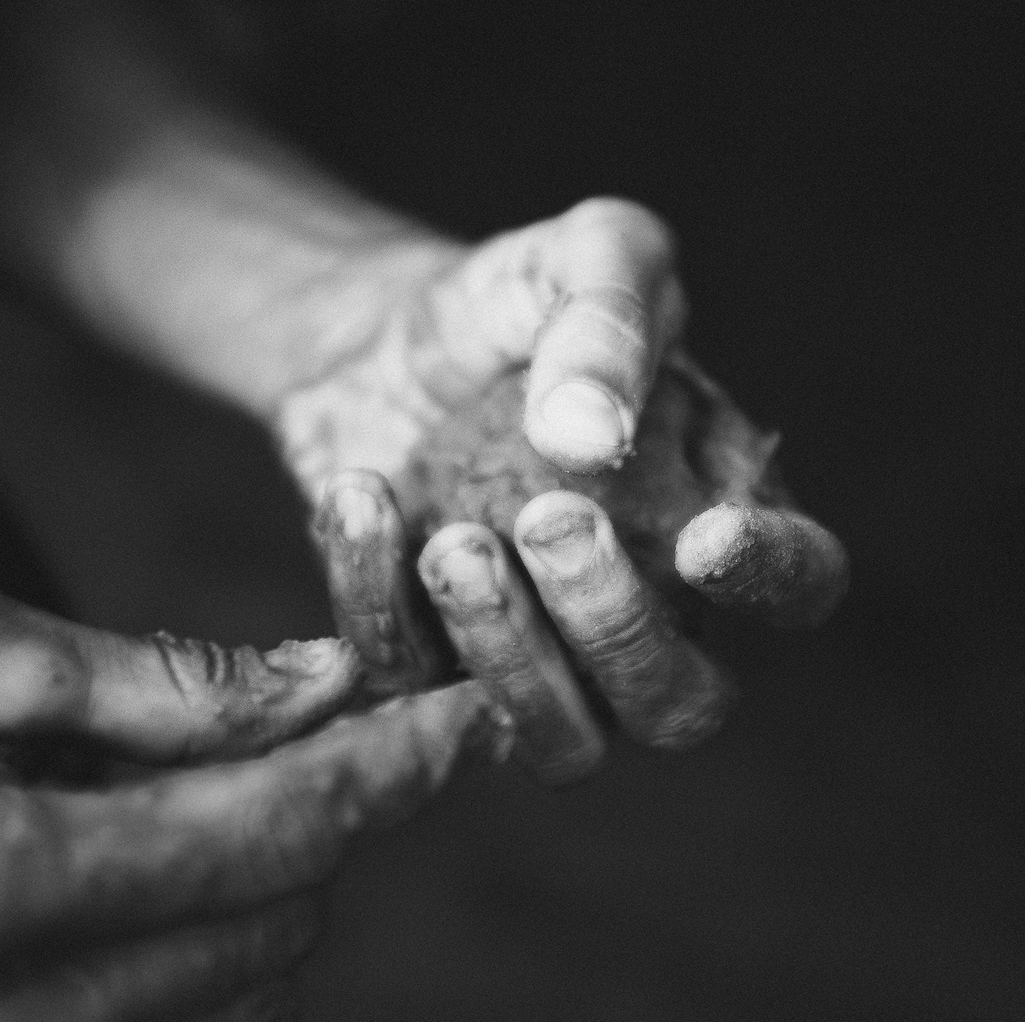 hands creating black and white close-up clay earth