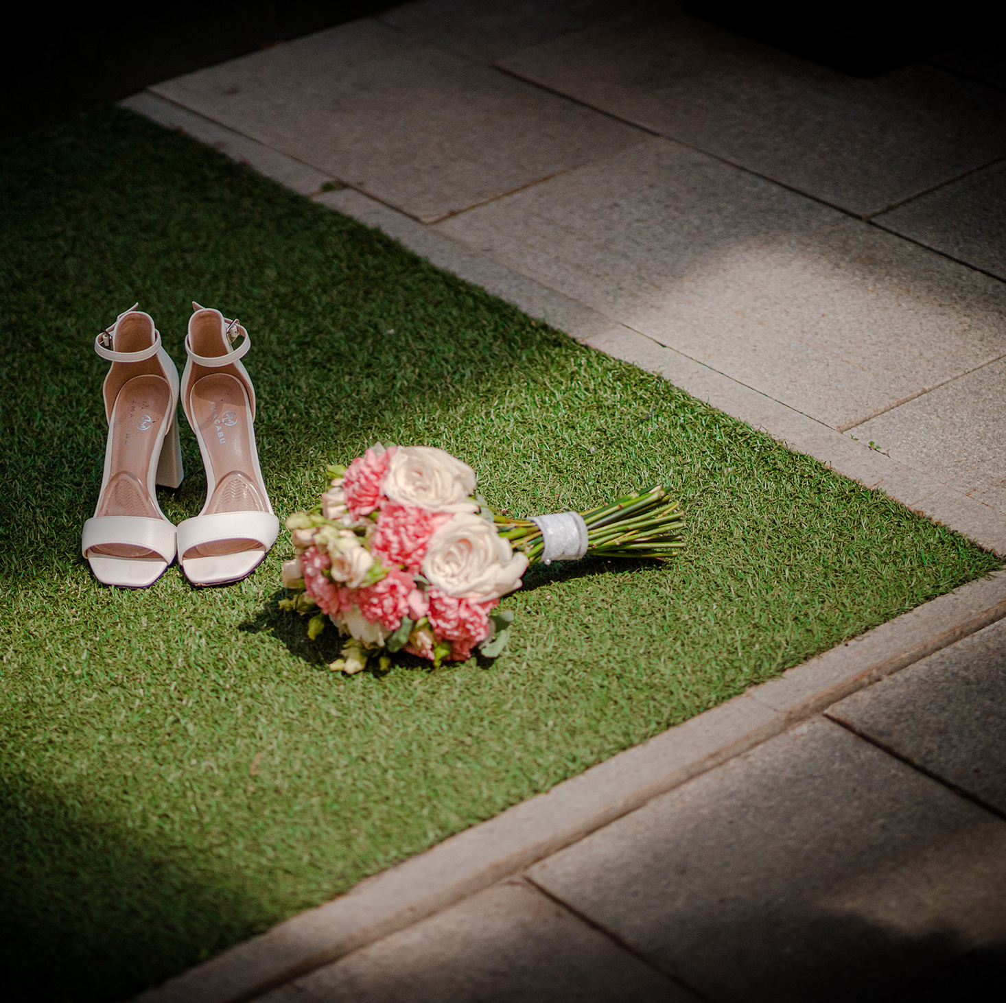 wedding shoes of the bride wedding bouquet on the grass